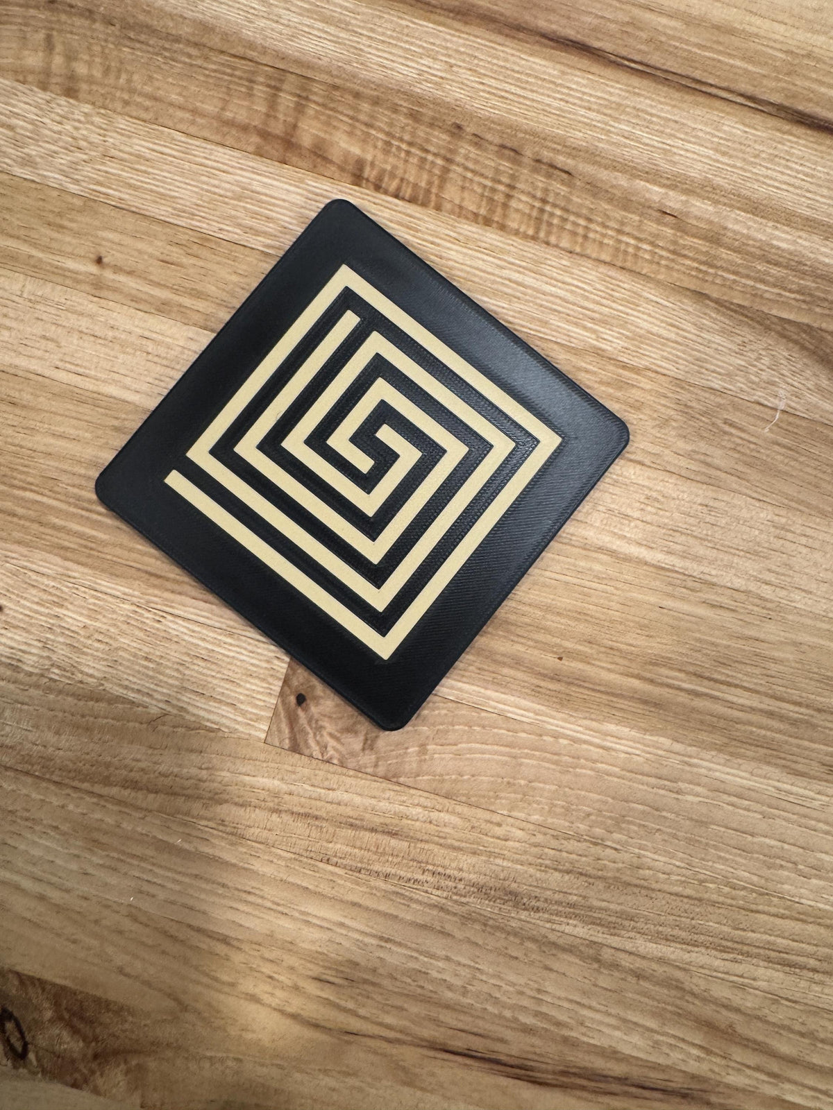 Mayan Labyrinth Coaster Set  striking black and tan/gold coasters that blend cultural artistry with modern design of Ancient Americas roots