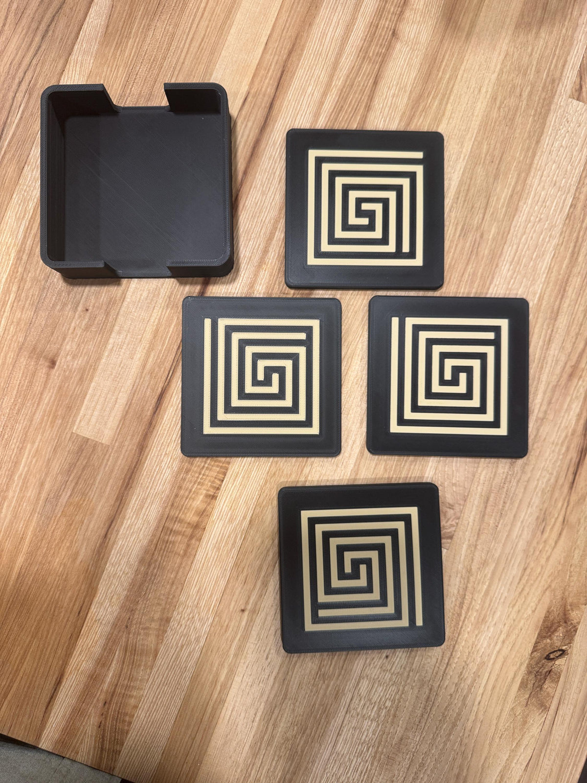 Mayan Labyrinth Coaster Set  striking black and tan/gold coasters that blend cultural artistry with modern design of Ancient Americas roots