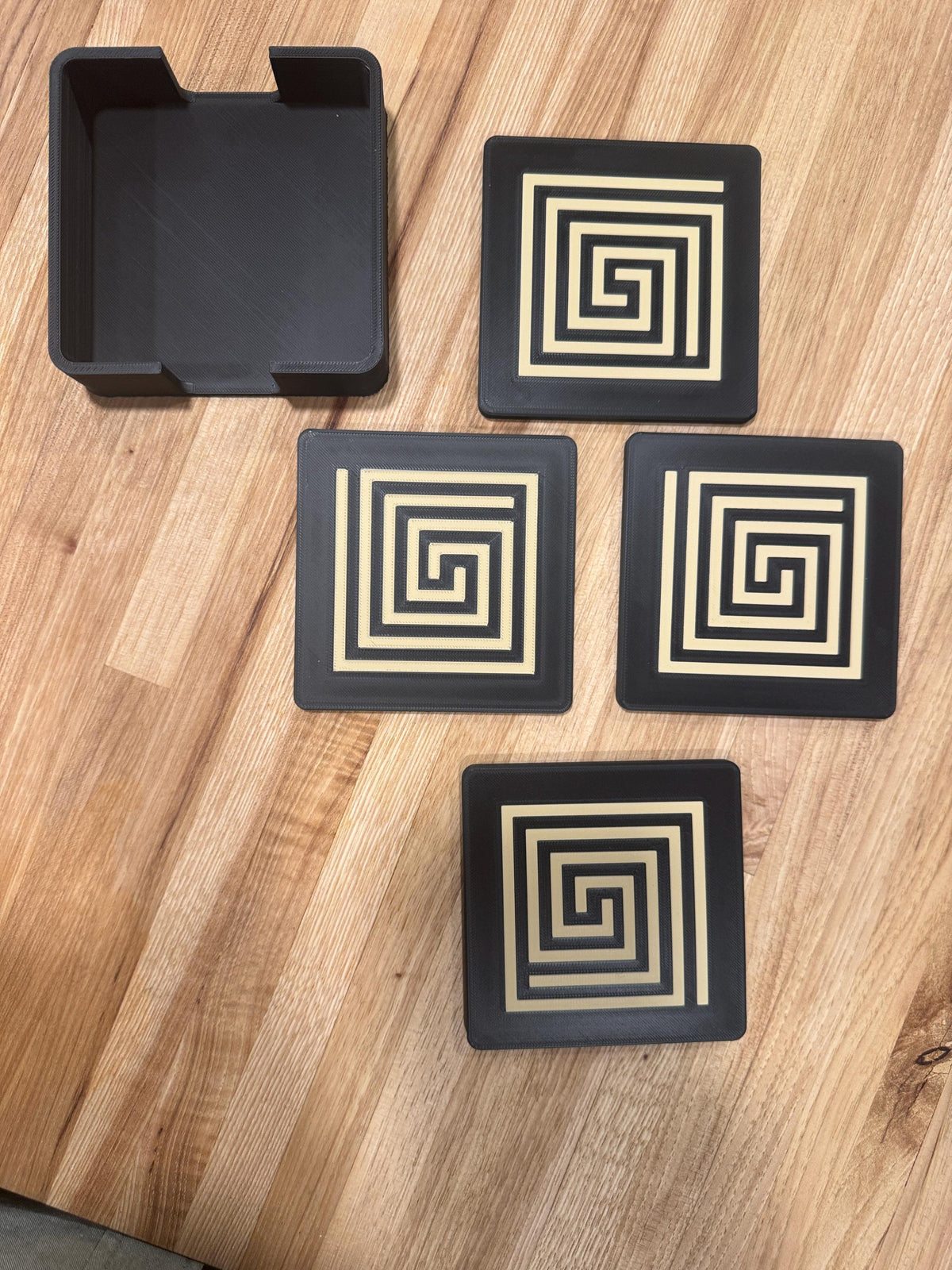 Mayan Labyrinth Coaster Set  striking black and tan/gold coasters that blend cultural artistry with modern design of Ancient Americas roots