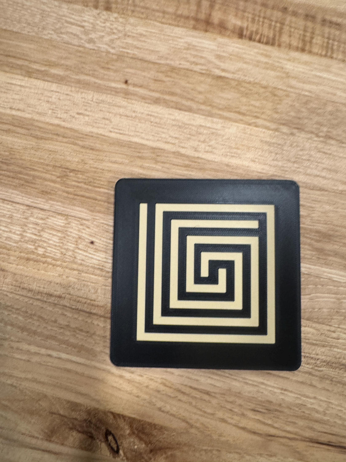 Mayan Labyrinth Coaster Set  striking black and tan/gold coasters that blend cultural artistry with modern design of Ancient Americas roots