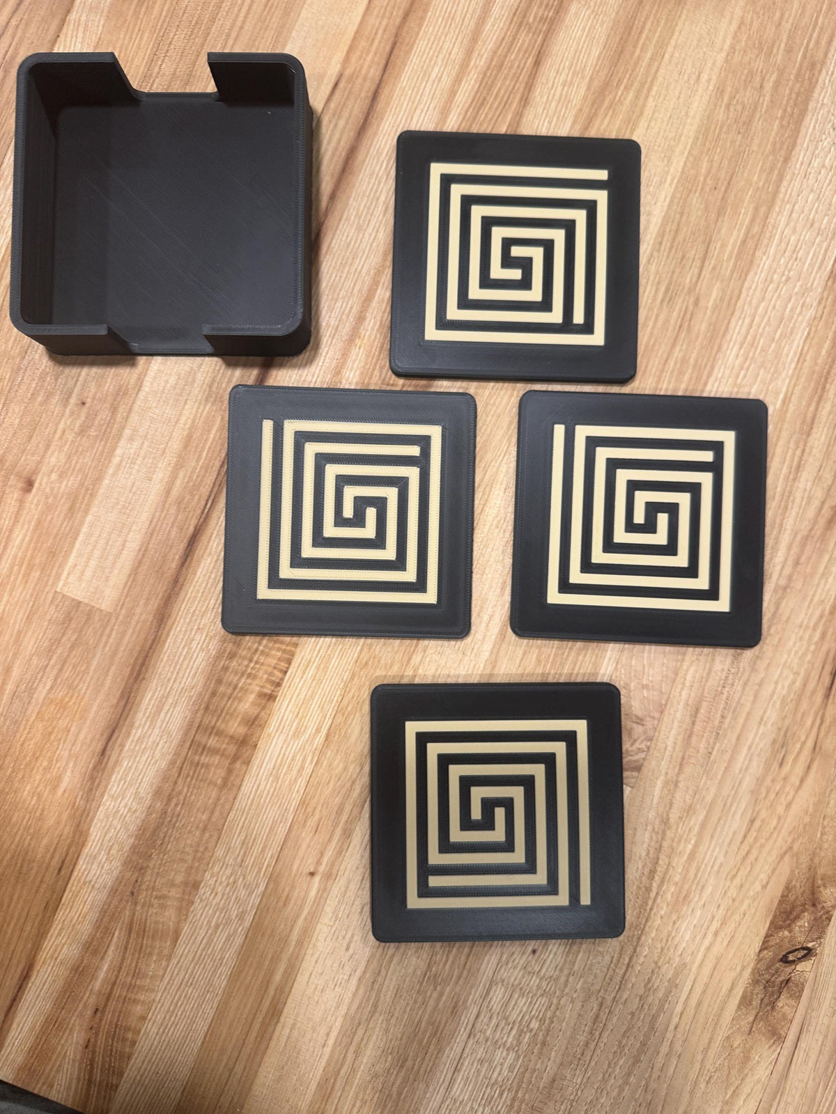 Mayan Labyrinth Coaster Set  striking black and tan/gold coasters that blend cultural artistry with modern design of Ancient Americas roots