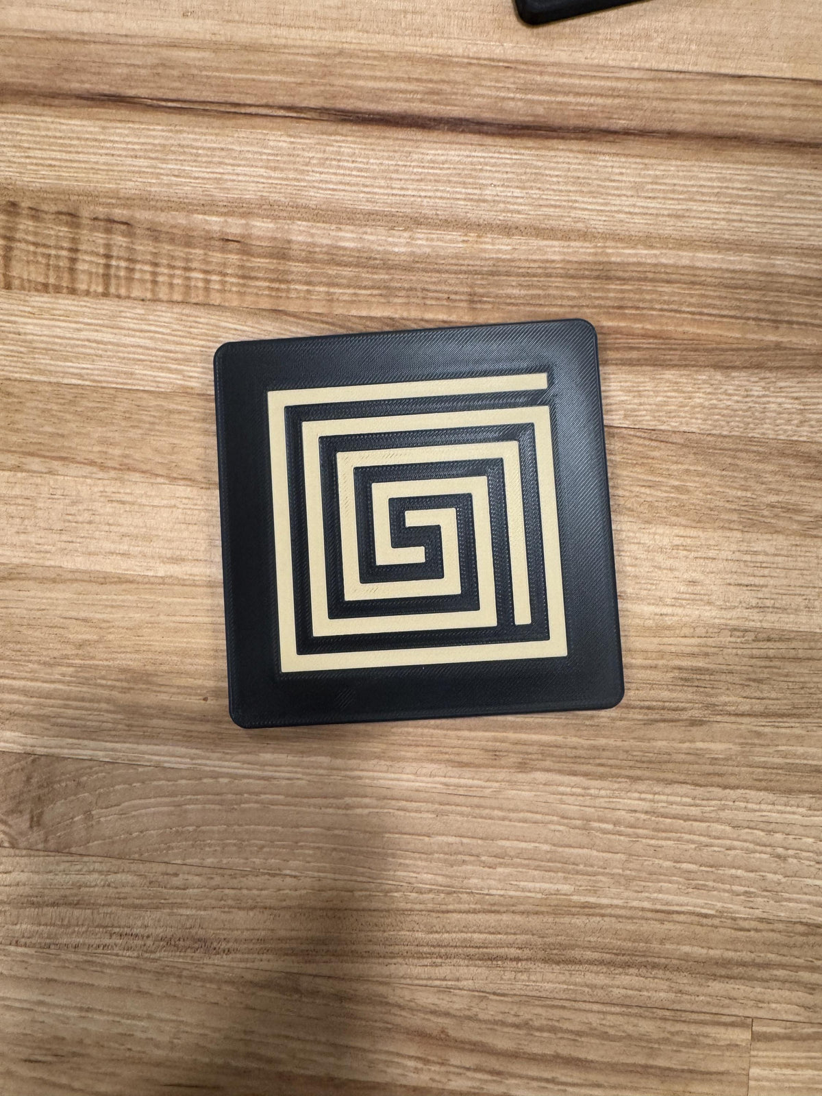 Mayan Labyrinth Coaster Set  striking black and tan/gold coasters that blend cultural artistry with modern design of Ancient Americas roots