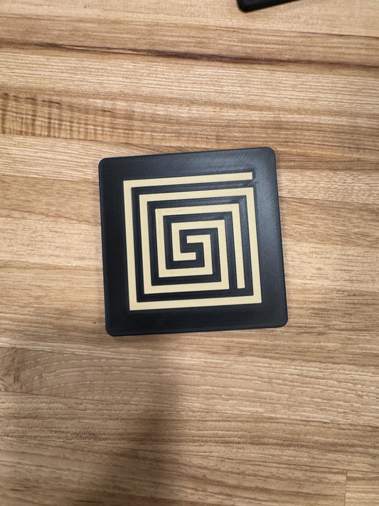 Mayan Labyrinth Coaster Set  striking black and tan/gold coasters that blend cultural artistry with modern design of Ancient Americas roots